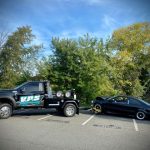 towing black compact car